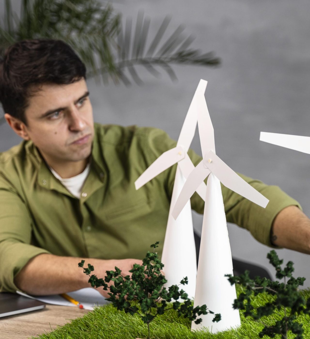 front-view-man-working-eco-friendly-wind-power-project-with-laptop-wind-turbines front-view-man-working-eco-friendly-wind-power-project-with-laptop-wind-turbines